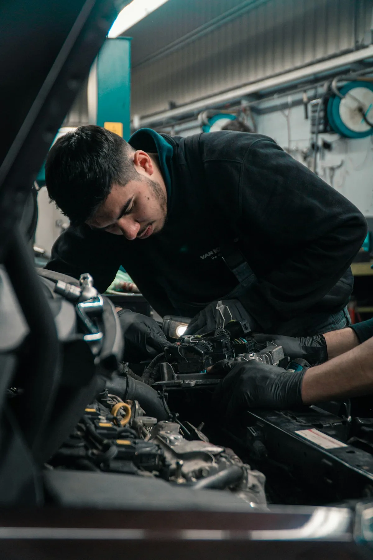 An RS technician working on a vehicle in the workshop